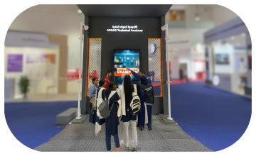 Students and guests play the Plinko Trivia Challenge at the ADNOC Technical Academy booth during a busy Dubai event
